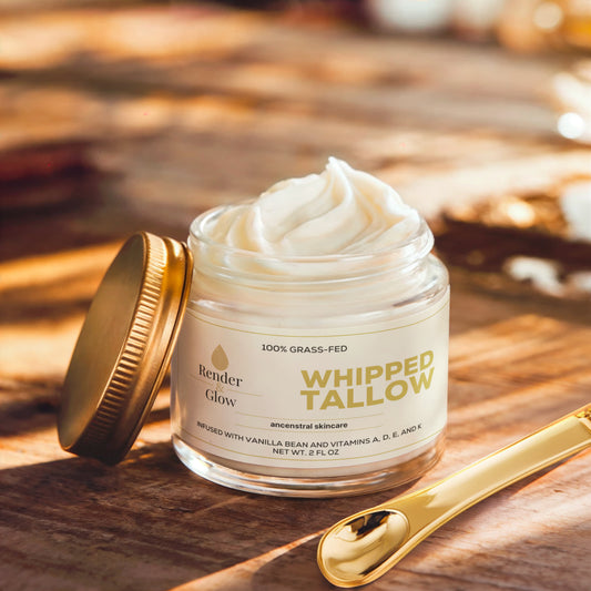Render & Glow Whipped Tallow Skin Balm with a golden lid and spoon sits on wood, illuminated by sunlight.
