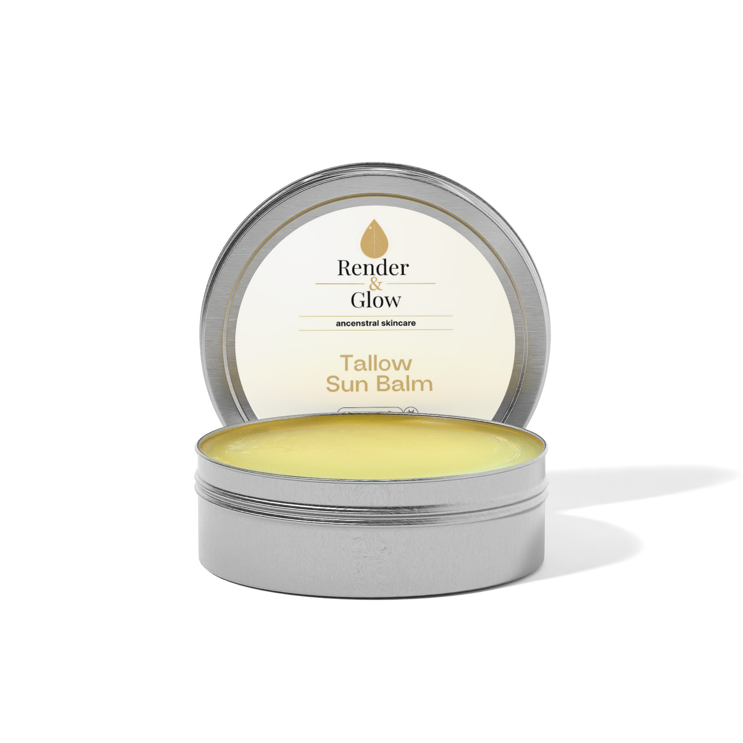 An open tin of Render & Glow Tallow Sun Balm reveals the yellow, natural sunscreen inside.