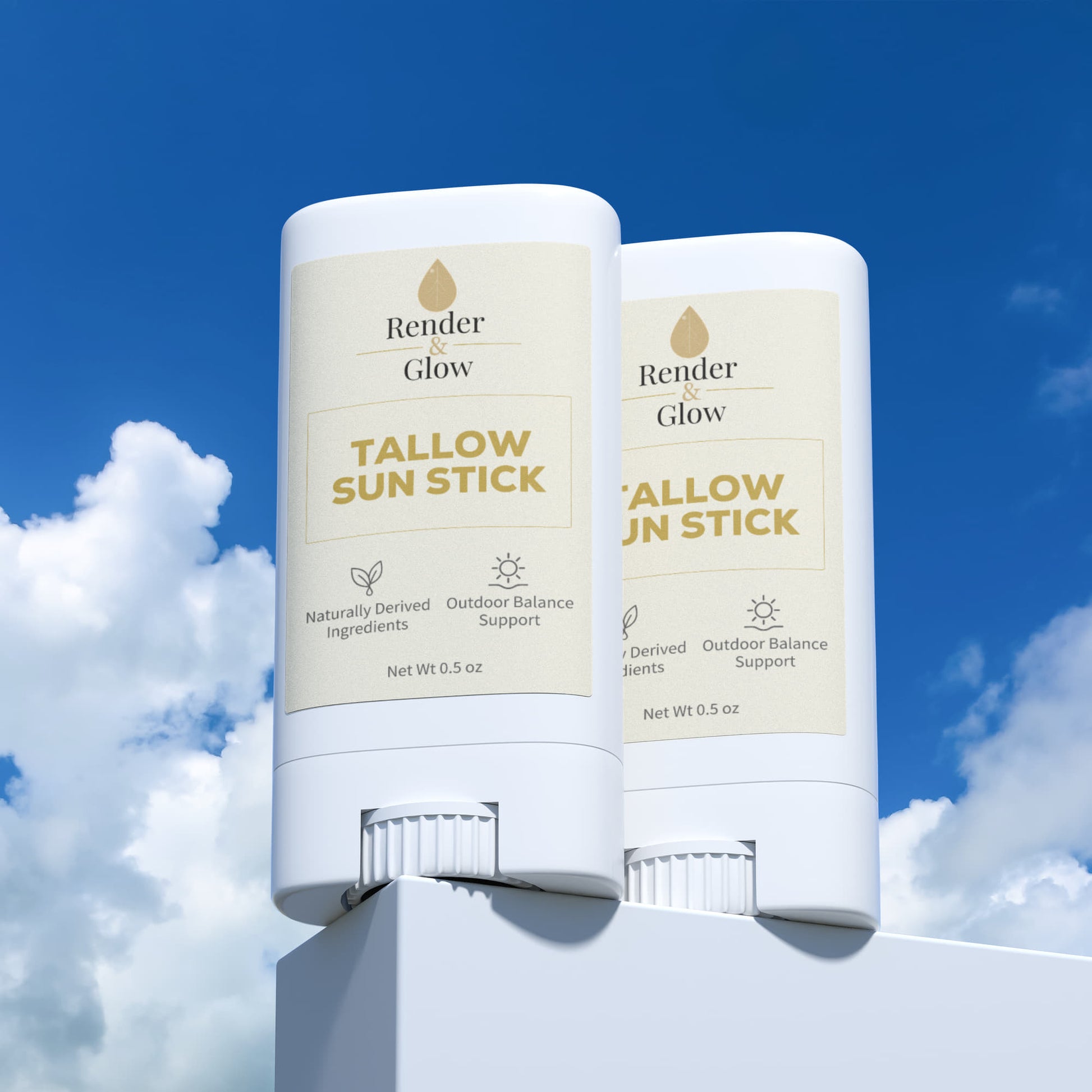 Two Render & Glow Tallow Sun Stick (2-Pack) tubes rest on white, framed by blue sky and clouds.
