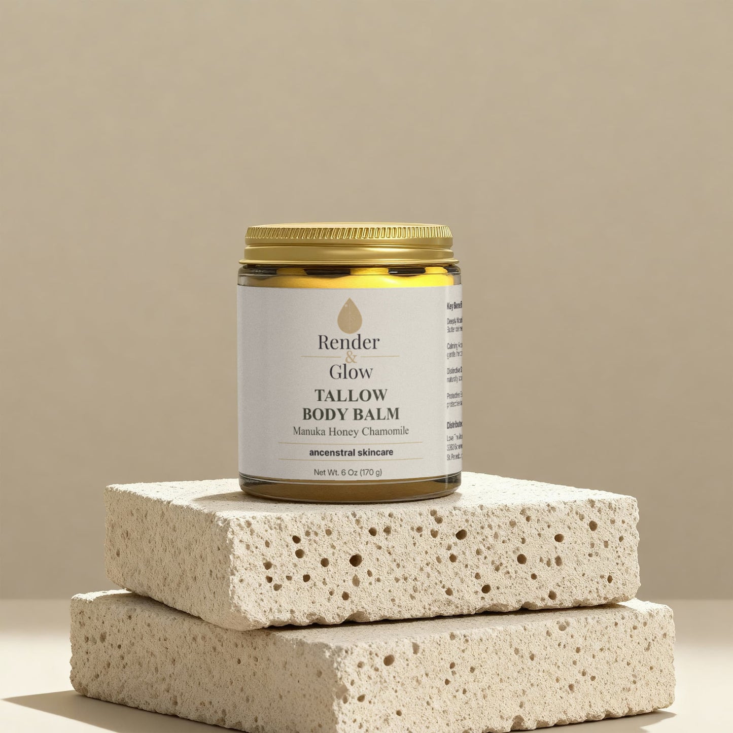 A jar of Render & Glow Tallow Body Balm rests on stone blocks against a beige background.