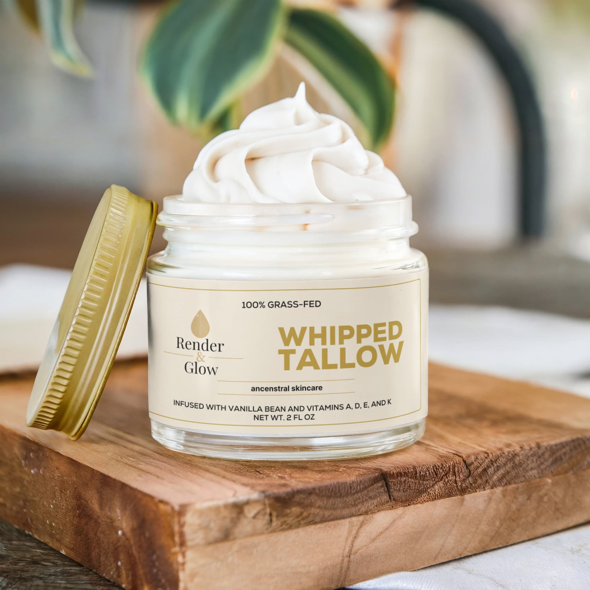 An open jar of Render & Glow Whipped Tallow Skin Balm sits on a wooden board, revealing its creamy texture.