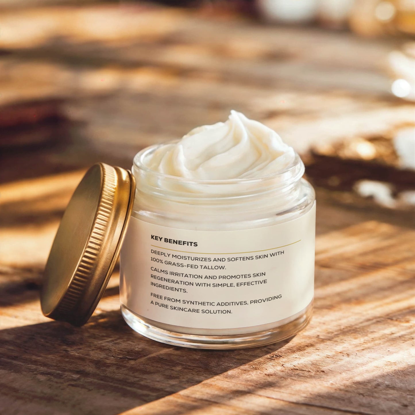 Render & Glow Whipped Tallow Skin Balm in a glass jar with gold lid, labeled natural skin moisturizer on wood surface.