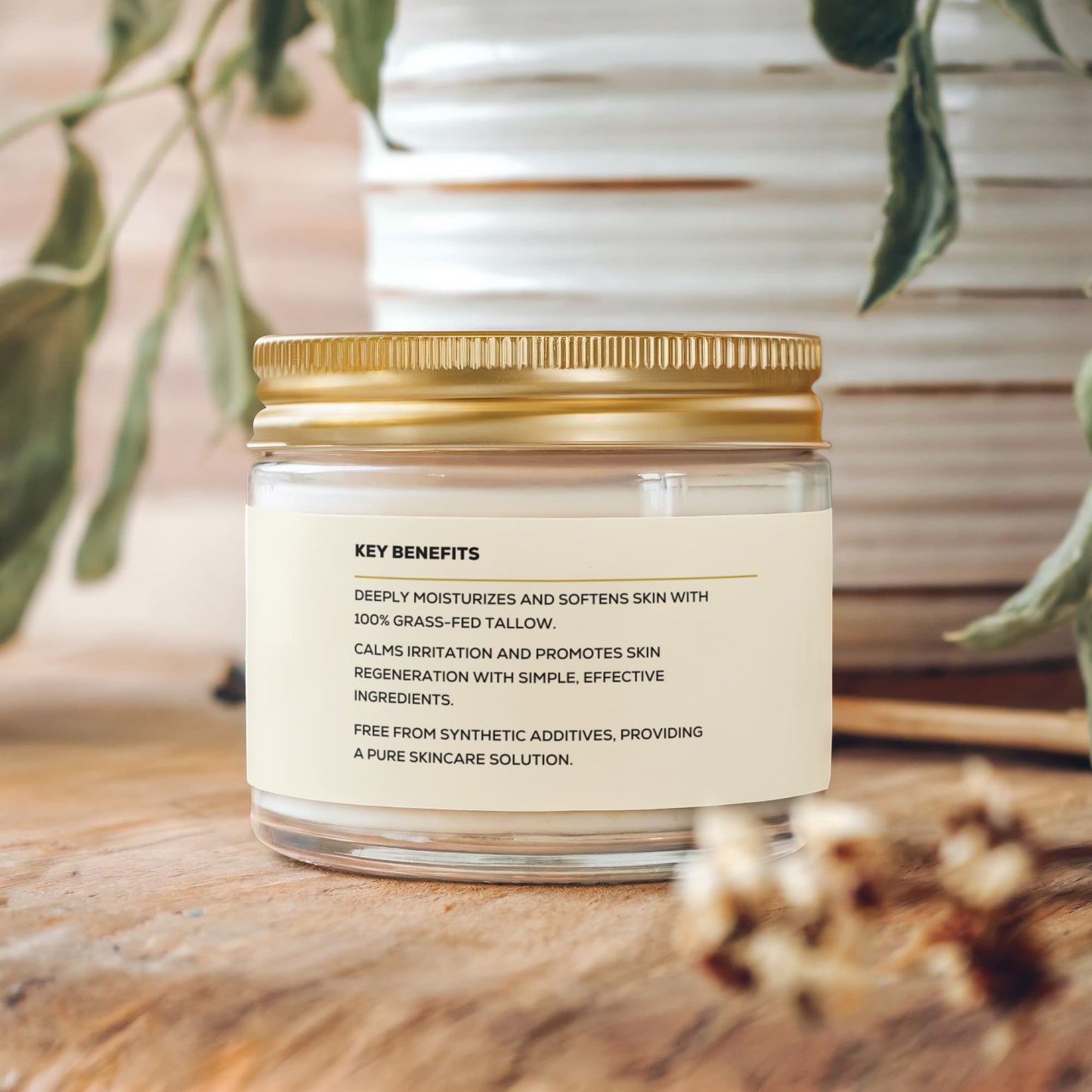 A glass jar with a gold lid and label for Render & Glow Whipped Tallow Skin Balm moisturizer.